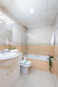 a bathroom with a toilet and a sink and a bath tub at BADIA DE ROSES 1 new apartment in Roses