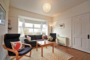 a living room with a couch and a table at Melvin Cottage in Embleton