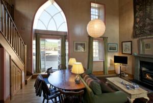 a living room with a table and a couch at Kirknowe in Jedburgh