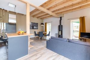 a living room with a blue couch and a kitchen at La Grange in Sommerau
