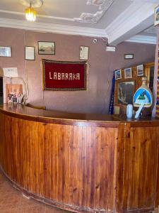 a bar in a restaurant with a sign on the wall at La Baraka Auberge in Aït Benhaddou