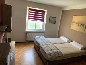 Een bed of bedden in een kamer bij LEA Apartments Leipzig West