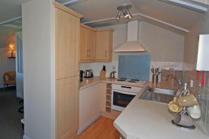 a kitchen with a sink and a stove top oven at Longstone in Embleton +2 photos