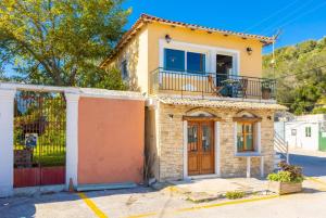a house with a balcony on top of it at Limani in Longós