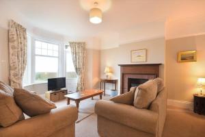 a living room with two couches and a television at Ty y Mor in Seahouses