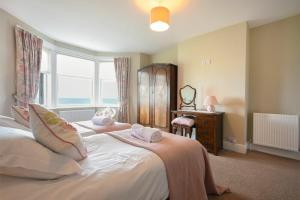 a bedroom with a bed with a window and a desk at Ty y Mor in Seahouses