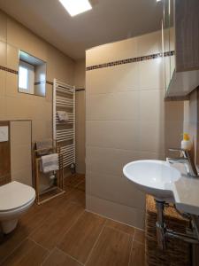 a bathroom with a white sink and a toilet at Ferienbungalow Sonnenwald Bayerischer Wald in Schöfweg