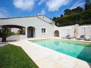 a villa with a swimming pool and a house at Les chambres d'hôtes de Mougins in Mougins