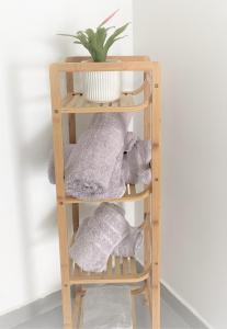 a wooden shelf with stuffed animals and a plant at Abbas BayView Apartment in Haifa +19 photos