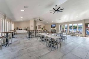 a dining room with tables and chairs and windows at Ramada by Wyndham Richfield UT I-70 in Richfield