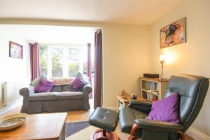 a living room with a couch and chairs and a table at Schooner Court No2 in Alnmouth