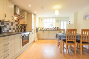 a kitchen with a table and a dining room at Schooner Court No2 in Alnmouth