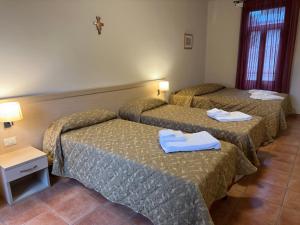 Postel nebo postele na pokoji v ubytování Domus San Bernardino