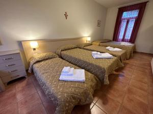 Postel nebo postele na pokoji v ubytování Domus San Bernardino