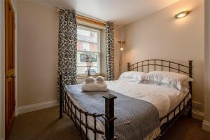 a bedroom with a bed with two towels on it at Pilots Rest in Alnmouth