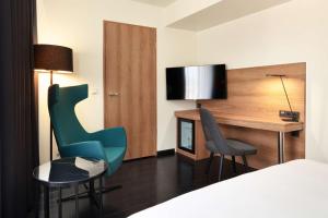 a hotel room with a desk and two chairs at Park Inn by Radisson Luxembourg City in Luxembourg