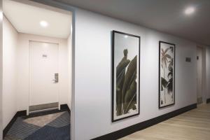 a hallway with three framed pictures on a wall at Travelodge Hotel Hobart in Hobart