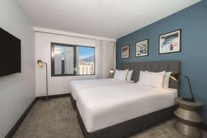 a hotel room with a bed and a window at Travelodge Hotel Hobart in Hobart