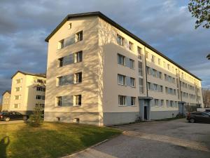 a tall white building with a lot of windows at Kuuse 4 Apartment with 2 bedrooms in Haapsalu