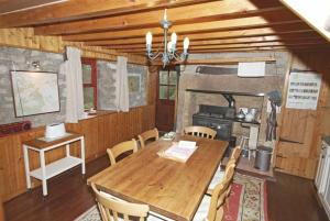 a dining room with a wooden table and chairs at The Old School House in Alwinton