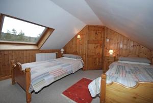 a bedroom with two beds in a attic at The Old School House in Alwinton
