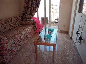 a living room with a couch and a glass table at Golf Porto Marina in El Alamein