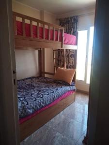 a bedroom with two bunk beds and a window at Golf Porto Marina in El Alamein