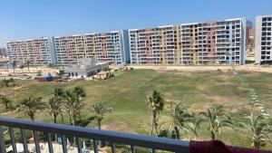 a view of a large apartment complex from a balcony at Golf Porto Marina in El Alamein