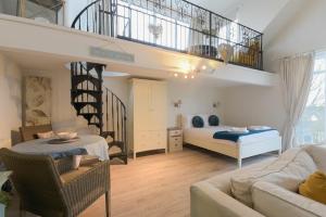 a living room with a bed and a staircase at The Snug in Embleton