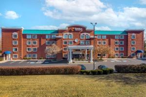a large red brick building with a parking lot at Comfort Inn & Suites in Brentwood