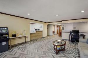 a living room with a couch and a tv and a kitchen at Comfort Inn & Suites in Brentwood
