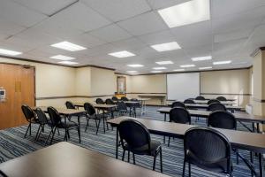 an empty classroom with tables and chairs and a whiteboard at Comfort Inn & Suites in Brentwood