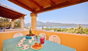 a blue table with food and drinks on a balcony at Apartments in residence with swimming pool in Porto Rotondo in Porto Rotondo