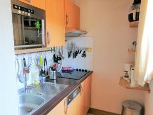 a kitchen with a sink and a counter with utensils at Appartement Morillon 1100, 3 pièces, 6 personnes - FR-1-412-55 in Morillon