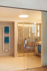 a bathroom with a shower and a sink at Strandhotel am Weissensee in Weissensee