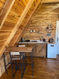 a kitchen with a table in a log cabin at Heaven Bungalow Fethiye in Fethiye