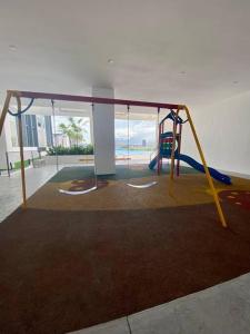 a play area with a slide and a playground at RUMA Executive Homestay Bukit Mertajam with Pool Netflix #FREETAX in Bukit Mertajam