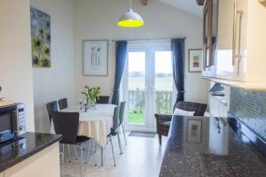 a kitchen and dining room with a table and chairs at Our Story Cottage in Long Houghton