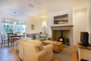 a living room with a couch and a fireplace at Periwinkle in Bamburgh