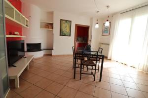 a living room with a table and chairs and a television at Elegant Holiday Home for 67 Guests in the Heart of Otranto in Otranto