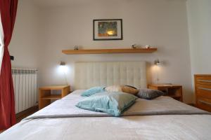 a bedroom with a bed with two pillows on it at Elegant Holiday Home for 67 Guests in the Heart of Otranto in Otranto
