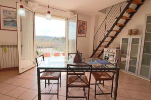 a dining room with a glass table and chairs at Elegant Holiday Home for 67 Guests in the Heart of Otranto in Otranto