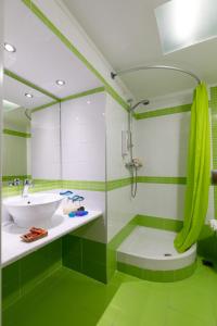 La salle de bains est pourvue d'une douche, d'un lavabo et d'une baignoire. dans l'établissement Sofia Hotel, à Plakias