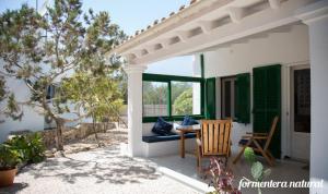 um pátio com uma pérgola, uma mesa e cadeiras em Casas Emma y Sofía - Porto Sale - Formentera Natural em Sant Francesc Xavier