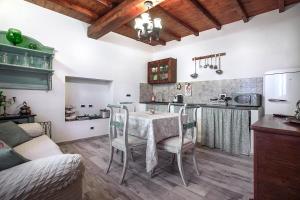 a kitchen with a table and chairs in a room at Il Castagno in Castiglione dei Pepoli