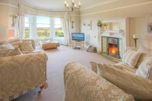 a living room with two couches and a fireplace at The Villas No3 in Embleton