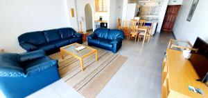 a living room with a blue couch and a table at Ramsgate Rendezvous 13 - Sleeps 6 - Great Sea Views! in Margate