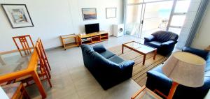 a living room with a couch and chairs and a table at Ramsgate Rendezvous 13 - Sleeps 6 - Great Sea Views! in Margate