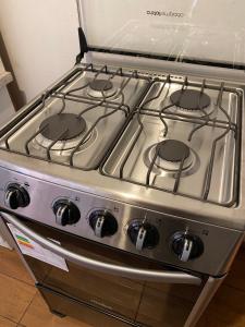a stove top oven with four burners on it at Casa y departamentos amoblados Talca in Talca