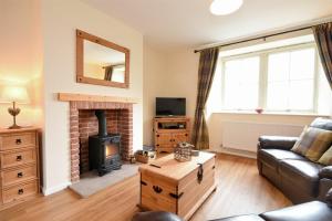 a living room with a couch and a fireplace at Castle View Glororum in Bamburgh